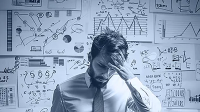 Dirigeant inquiet devant un mur de graphiques et de données, illustrant la complexité croissante des obligations réglementaires